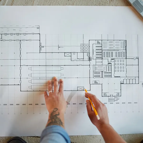 Man working on construction blueprints